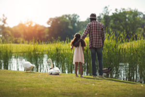 Older black man in nature with his grandchild
