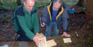 Participant (with ranger) making a bird box.
