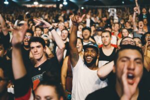 Smiling crowd with raised arms