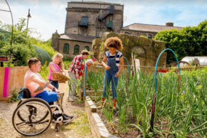 young people of different abilities working together in community garden