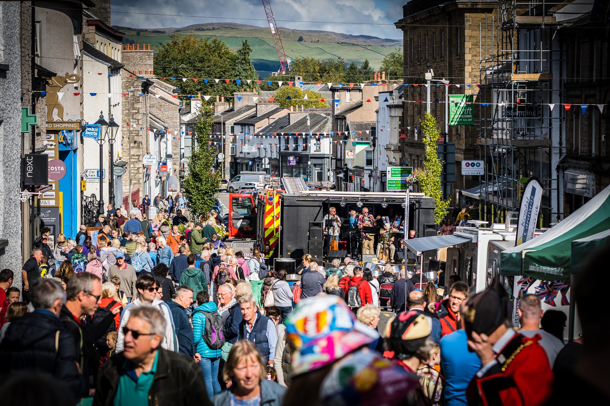 Road closed for public street party in lake district down with band and milling crowds